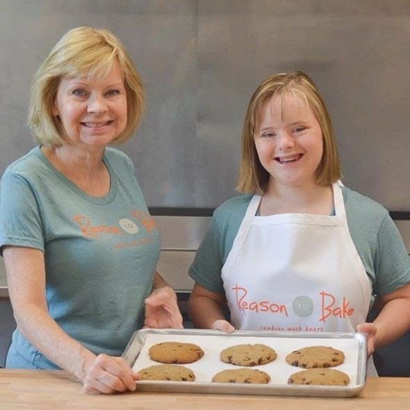 mom and down syndrome daughter make cookies together