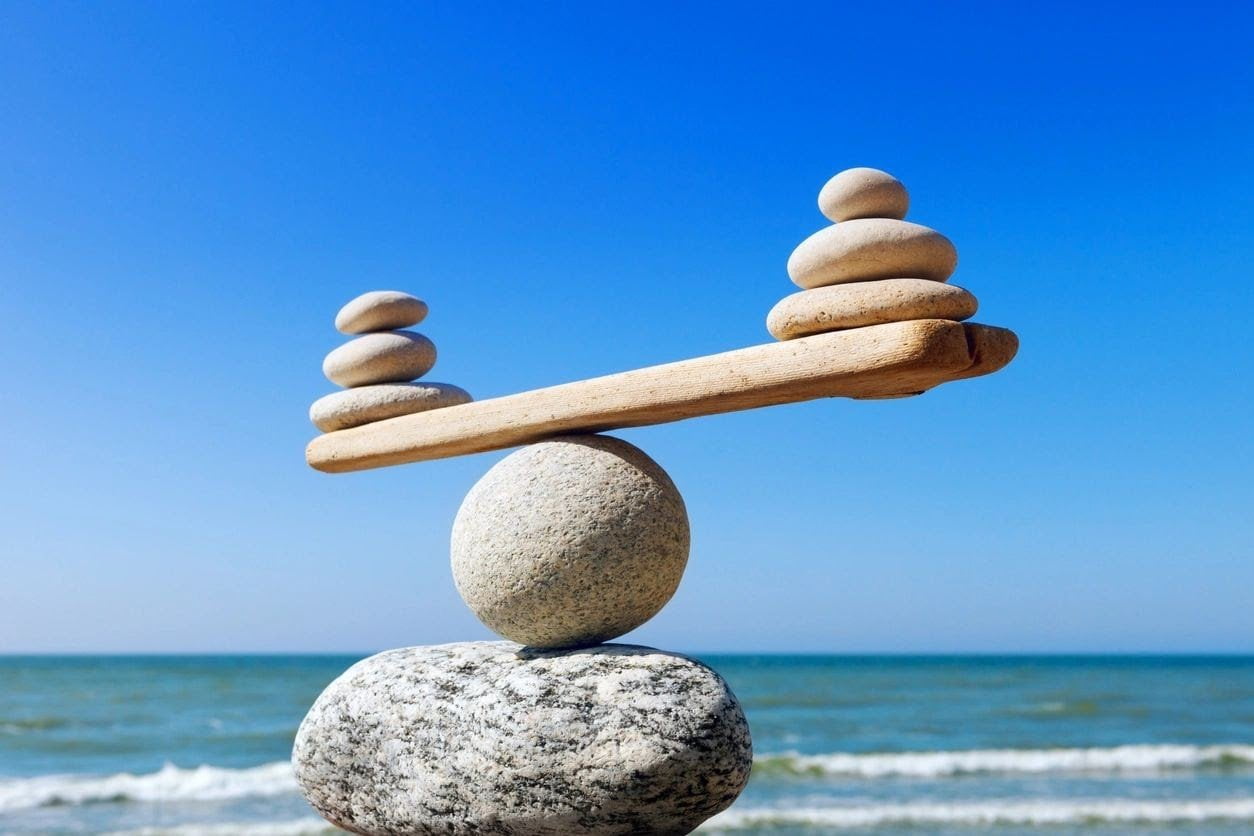 rocks balanced on the edge of a shoreline