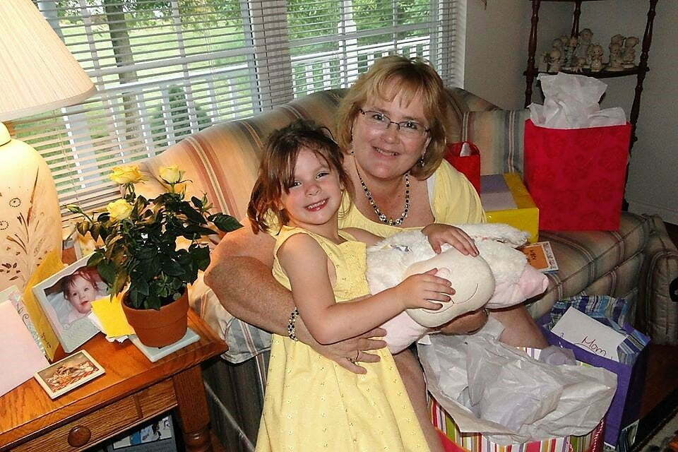 grandma and granddaughter dressed in yellow smiling at the camera