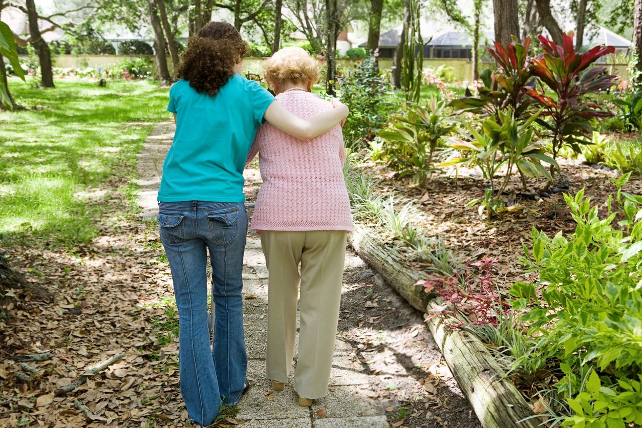 two women walking together in nature