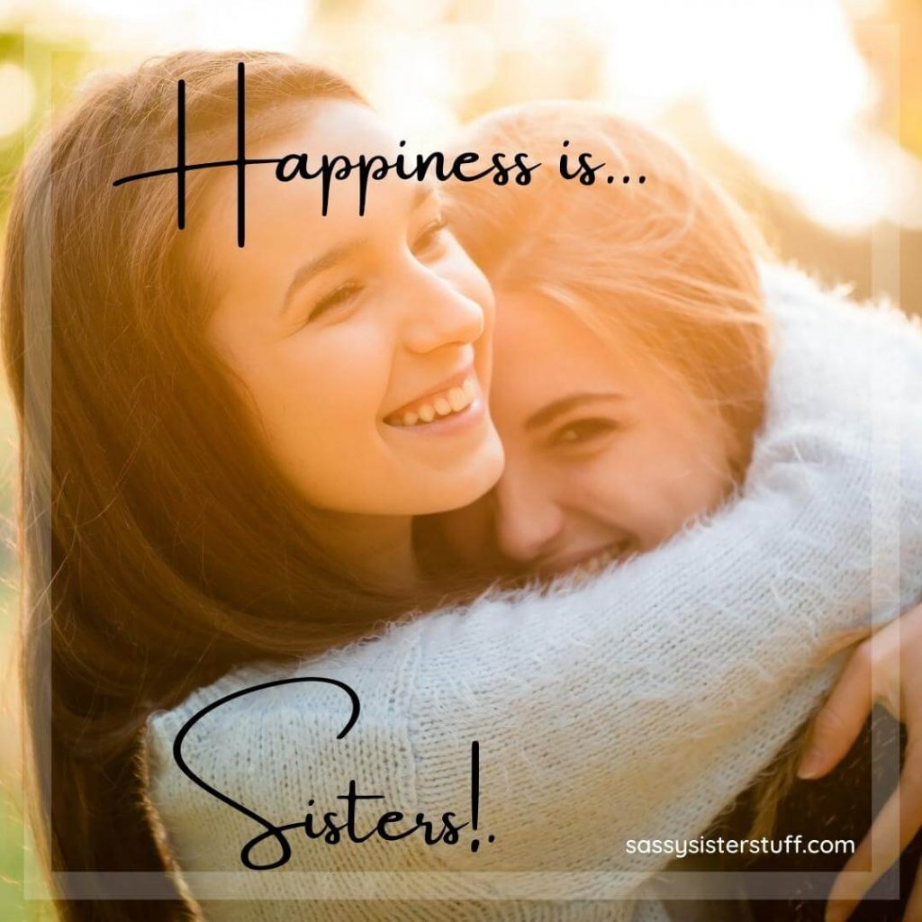 two sisters hug each other smiling and words that say happiness is sisters
