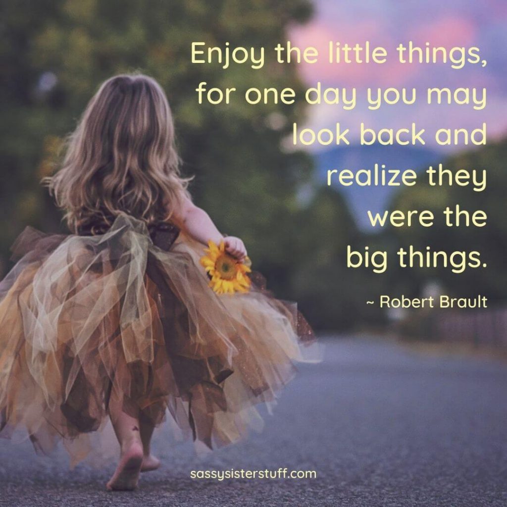 a little girl runs down the street toward the sunset with a quote about the little things