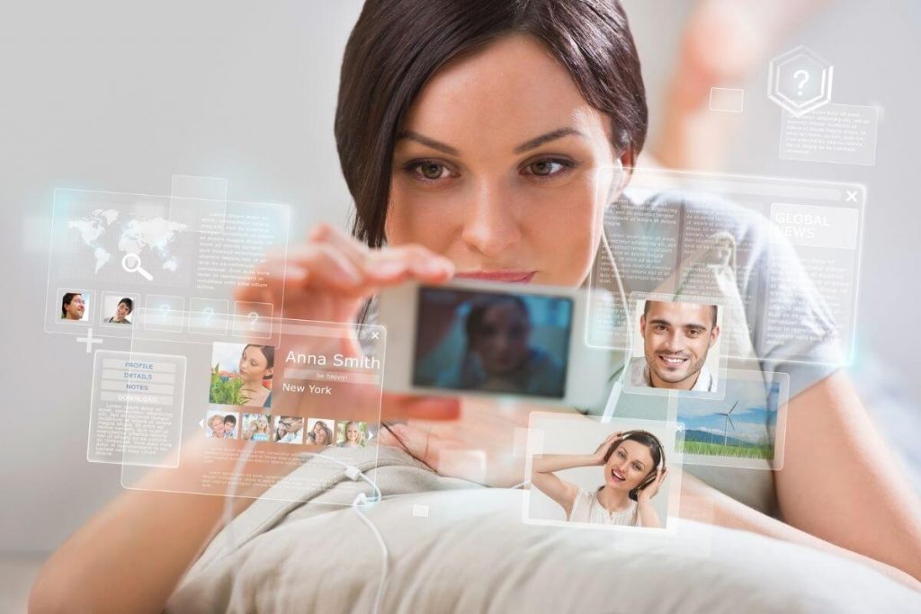 happy woman looks at multiple social media platforms on her phone