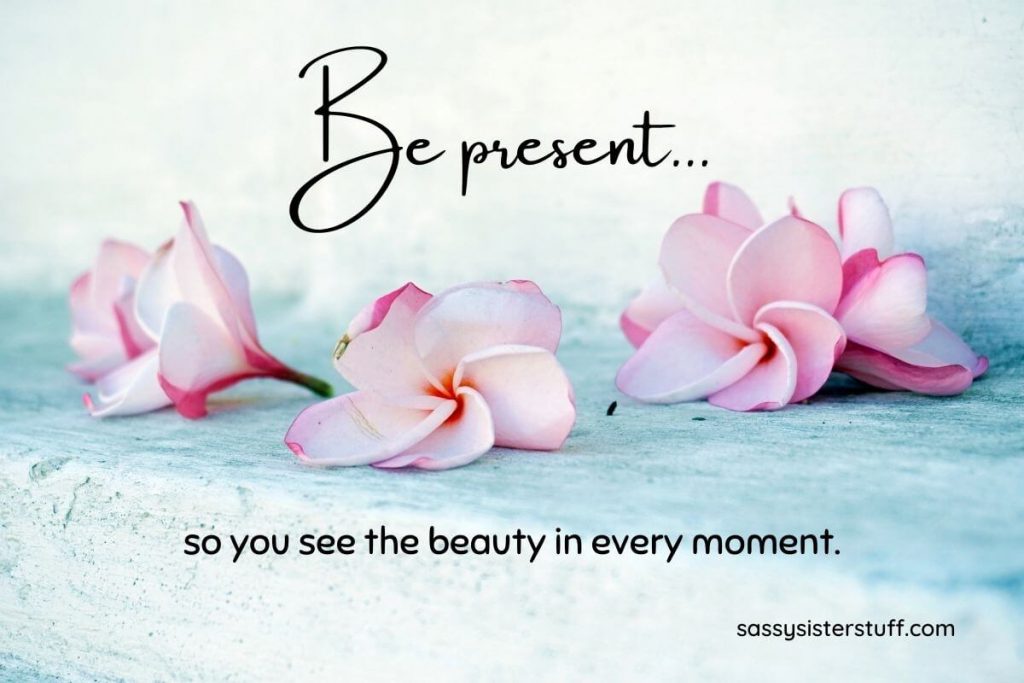 pink flowers on a light blue background with a quote about being mindful and present
