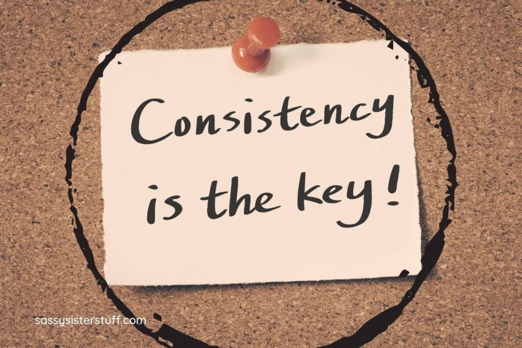 consistency is the key written on a note and thumb tacked to a cork board