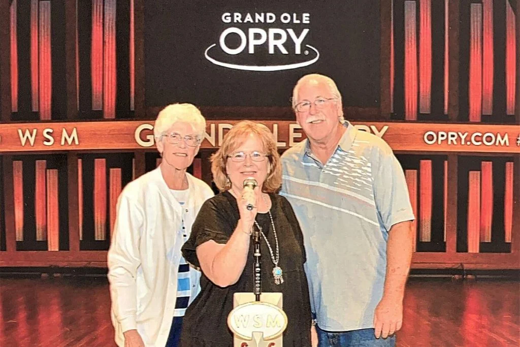 three visitors have family fun in Nashville on the Grand Ole Opry stage