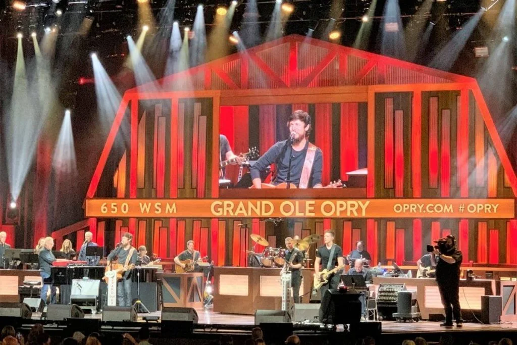 Chris Janson performing on stage at the Grand Old Opry