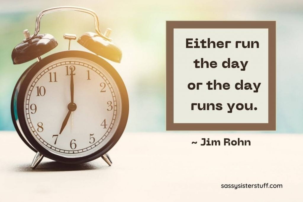 old fashioned clock sitting on a table and a quote about time management