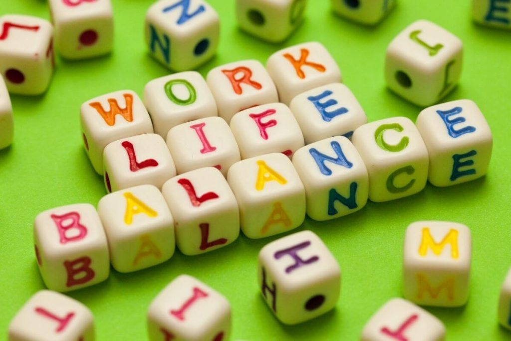 many brightly colored letter dice spelling work life balance