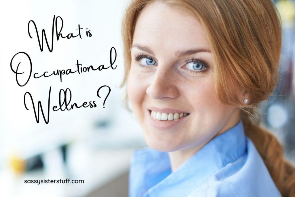 a happy woman at work in an office smiles because she has occupational wellness