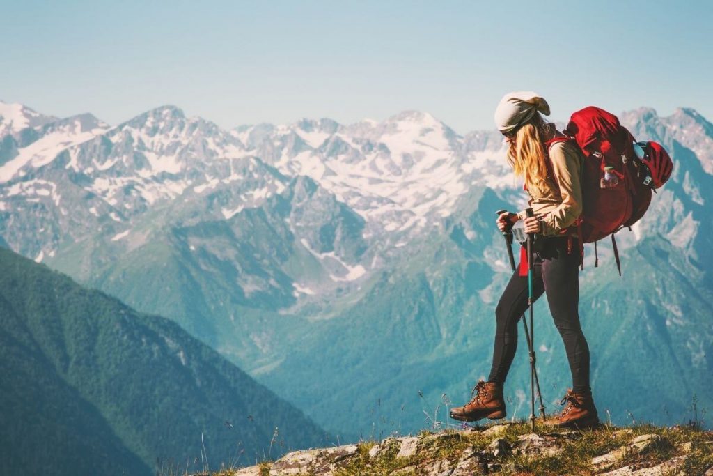 a woman hikes through snow capped mountains in her exploration of why is life beautiful