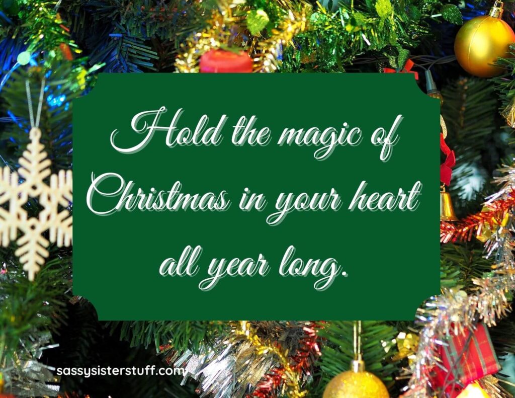 brightly decorated christmas tree with a christmas message on a green rectangle in the center