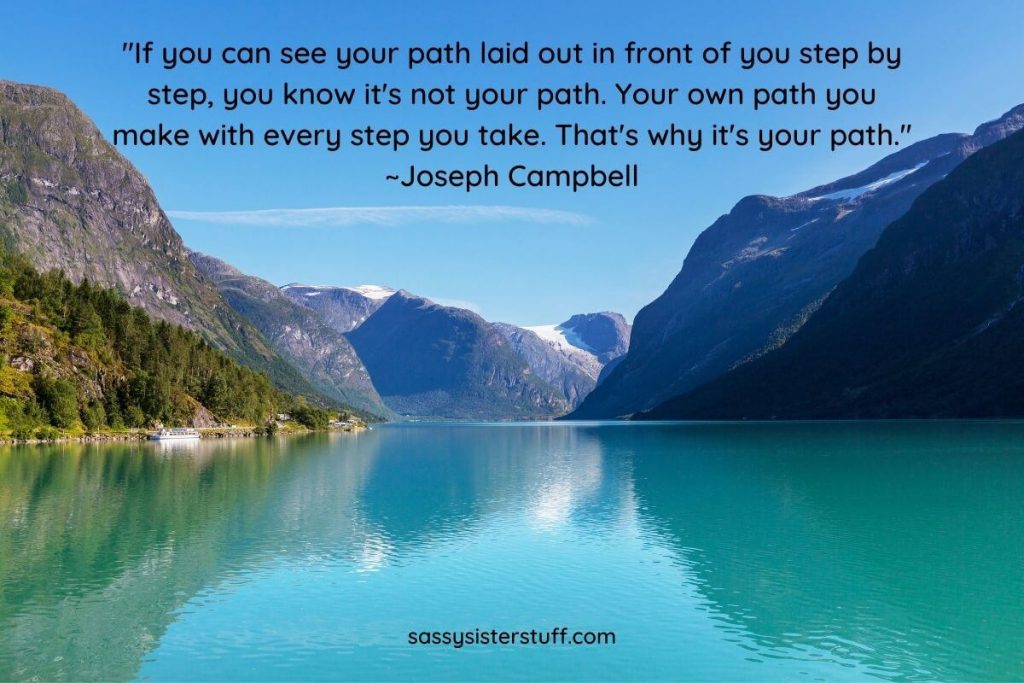 a large blue lake with mountains in the background and a quote about finding your own path in life