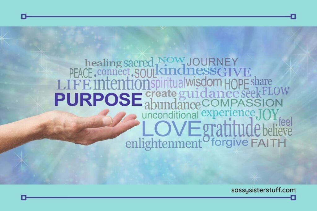 a hand reaches out toward some words associated with passion and purpose in life such as intention gratitude journey believe