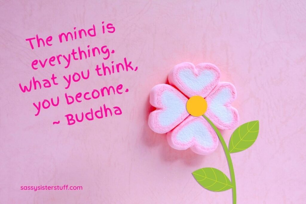 pink background with a pink candy flower made from hearts and a quote about mindset