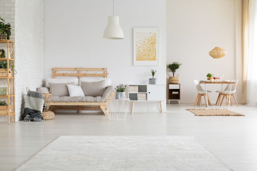 a simple minimalistic living room and small dining room decorated in shades of white and beige as a wonderful example of slow living