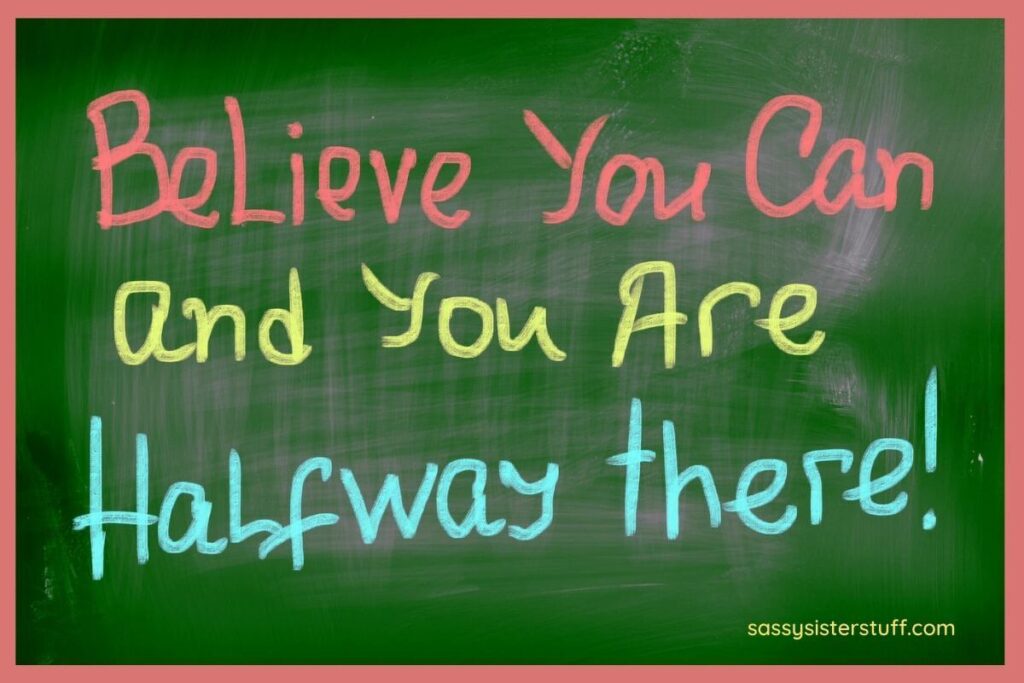 green chalkboard with brightly colored words that say believe you can and you are half way there