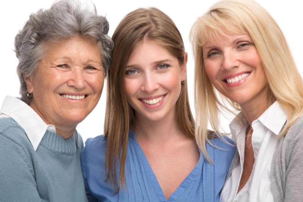 three ladies of different ages and generations show the effects of affirmations for confidence by smiling and demonstrating they have good self-confidence