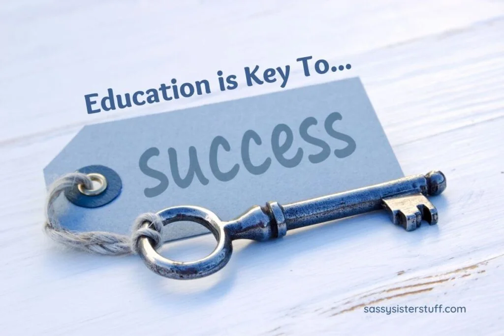 an old silver key attached to a note that says education is key to success lays on a gray wooden table