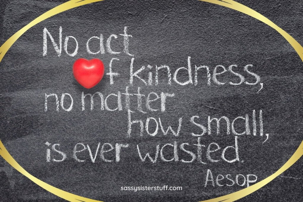 a black chalkboard with a kindness quote from aesop written in white chalk and a gold shiny oval around the quote