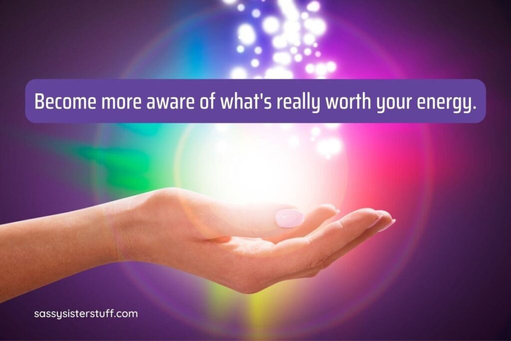 a bold background in purples greens pinks yellows blues and whie with a hand holding an energy sphere and an inspirational quote about your energy