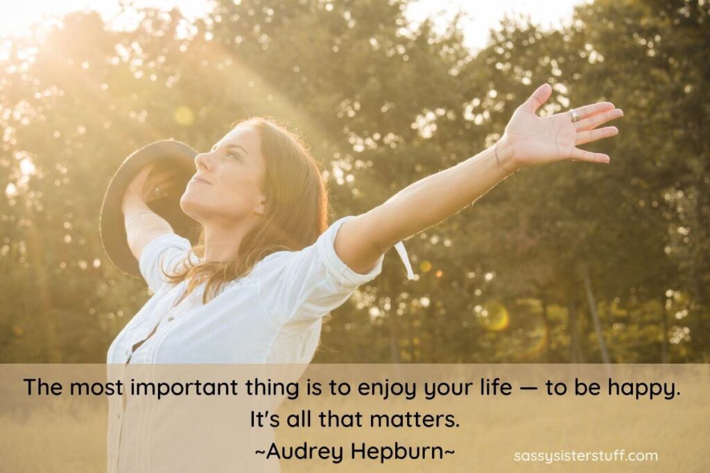 a young woman throws her arms up in the air in happiness and one of many choose happiness quotes