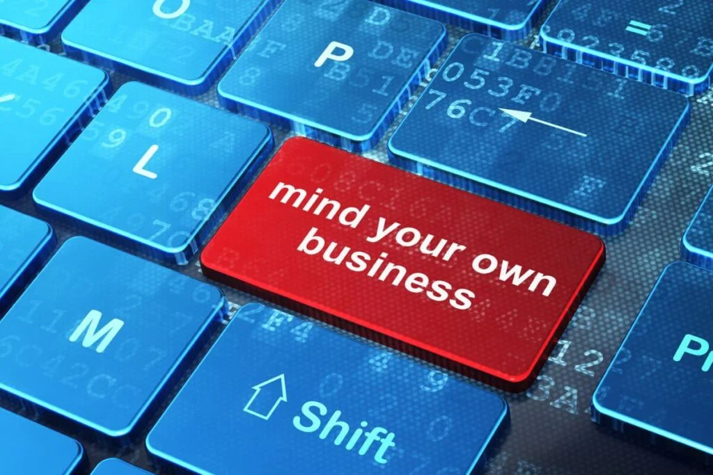 a compute keyboard with a red mind your own business button