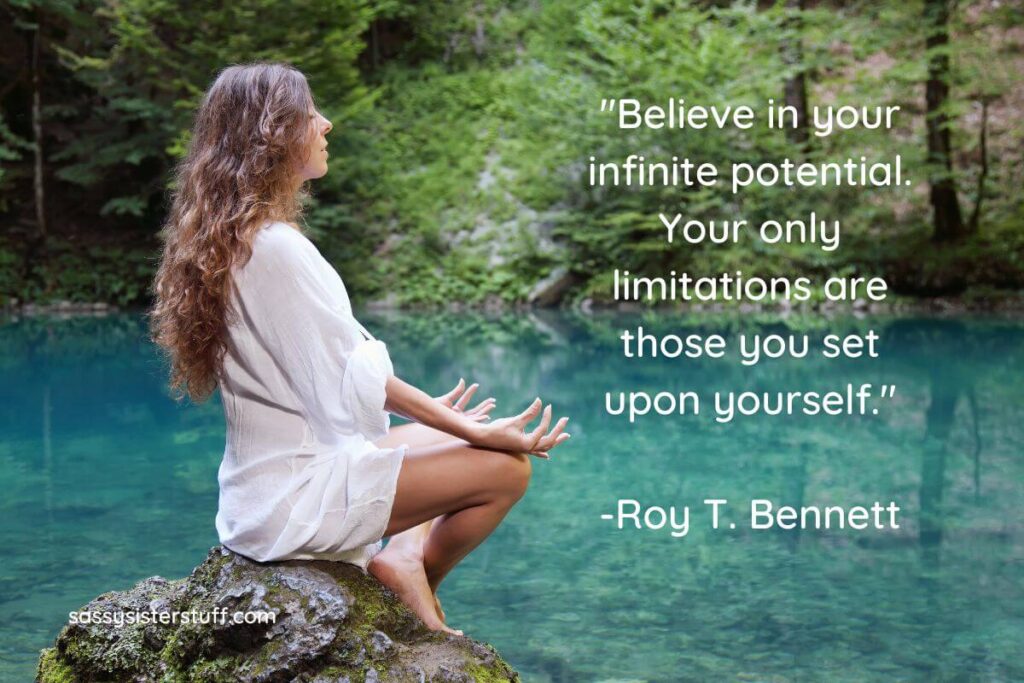 a young woman sits on a large rock next to a lake while meditating and a quote about spirituality