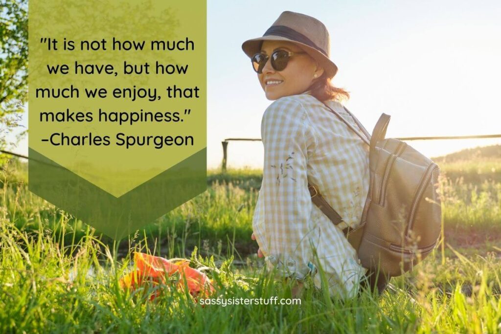 a happy woman wearing a backpack rests in a field of wild grass plus a quote that says we should be content with what life gives us