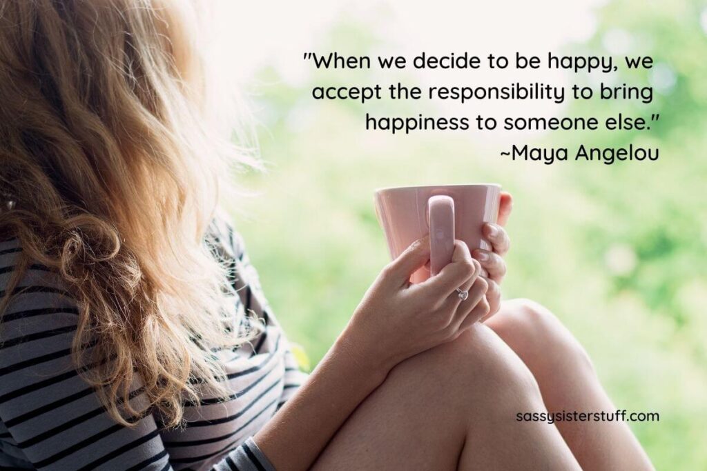 a woman with long hair holding a mug sits on a window sill and reflects about how we should be content with what life gives us plus a quote from Maya Angelou about happiness