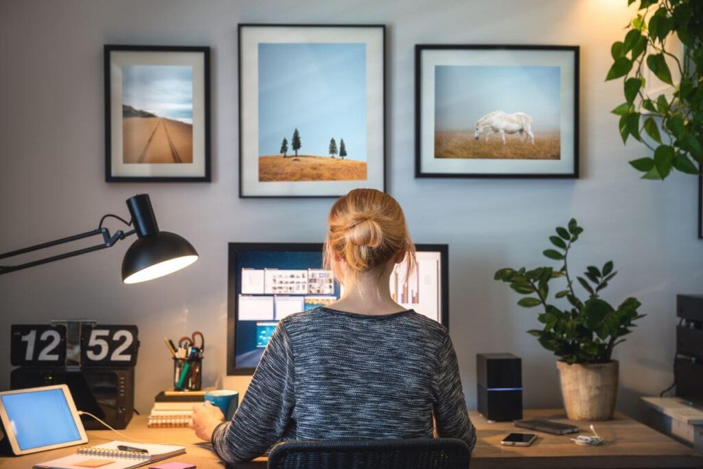 a remote worker works at her desk in a comfortable home office space