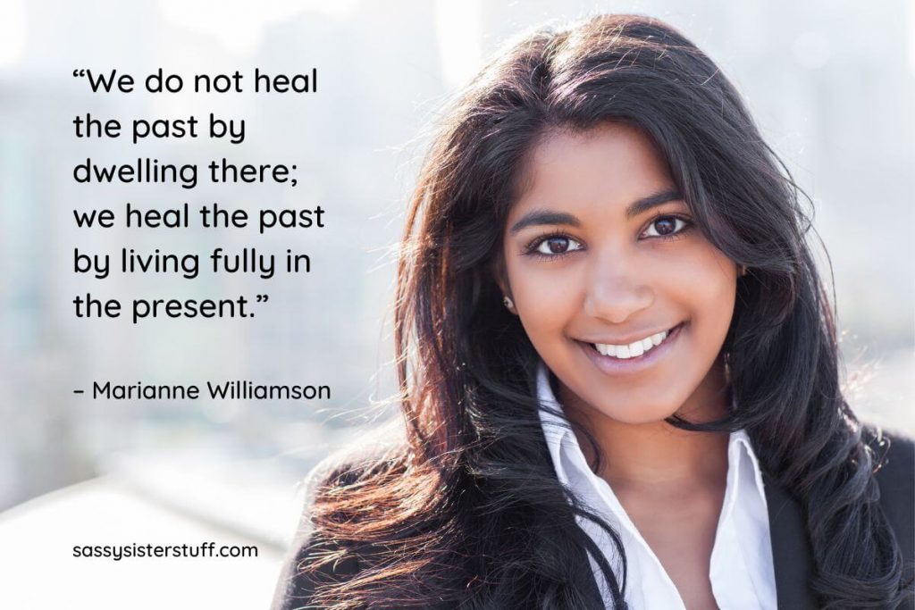 a smiling woman and a quote about living fully in the present and letting go of the past