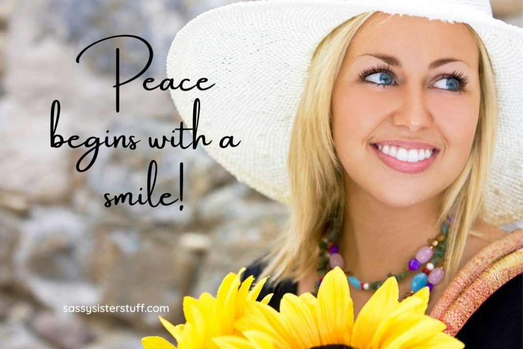 a young woman smiles and carries bright yellow flowers because she knows peace of mind begins with a smile