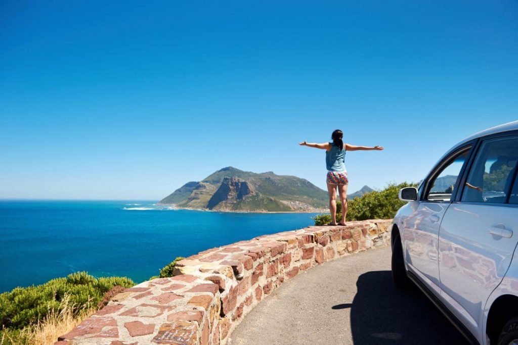 a young woman stands on an overlook in South Africa in awe of the beauty