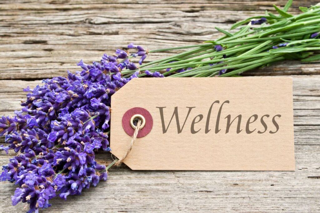 stems of lavender flowers with a tag that reads wellness
