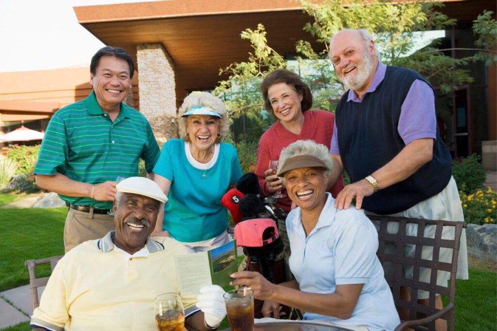three middle aged happy couples pose for a photo after an enjoyable day of golf