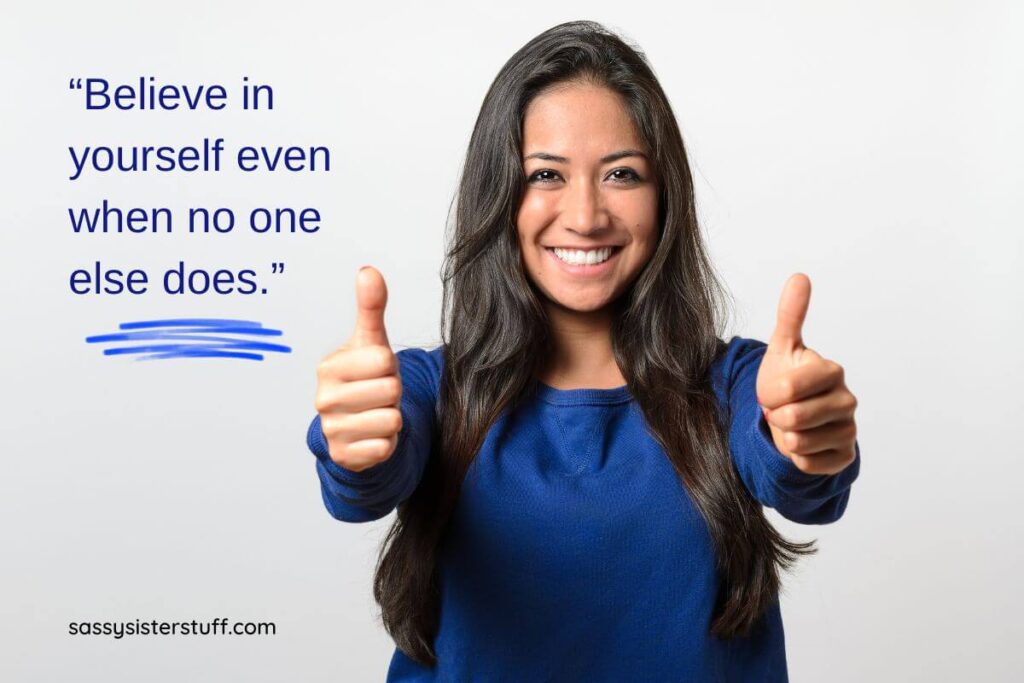 a women shows two thumbs up with a big smile on her face and a quote says Believe in yourself even when no one else does