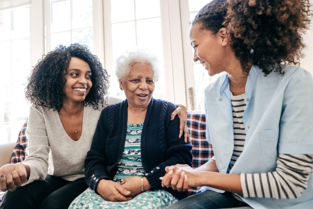 a woman and her elderly mother meet with a respite care worker who is going to help them find balance