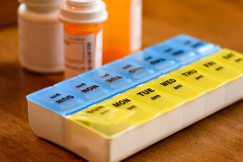 close up of two weekly pill containers that should be used when you create an at-home care plan