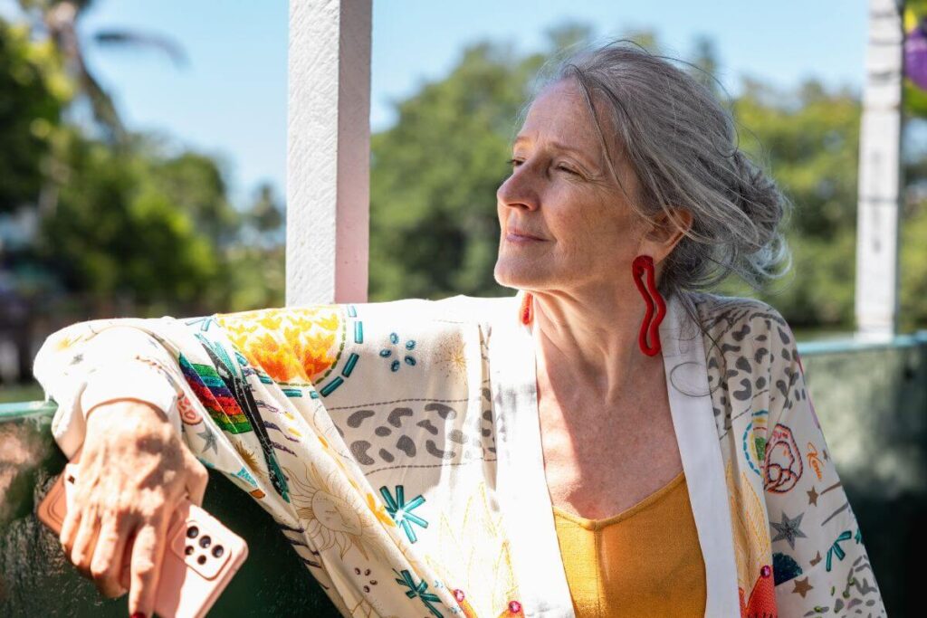 a middle aged woman relaxes on her patio and reflects about finding purpose in life after 50