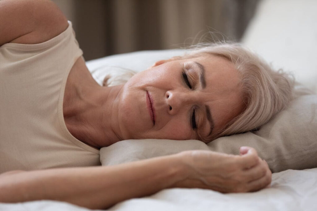 a middle aged woman takes care of her health by taking a nap when she's tired