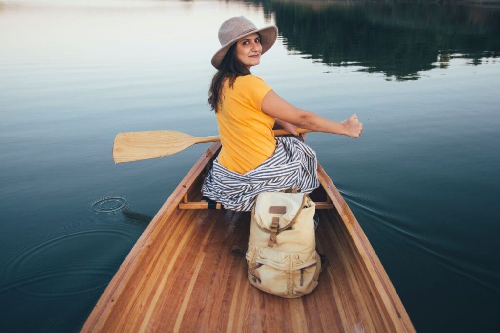 a middle aged woman tries something new and paddles out on a lake in a canoe by herself as part of her mission of finding purpose in life after 50