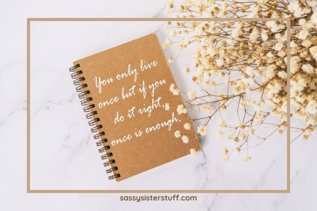 top view of a note with the quote "you only live once but if you do it right once is enough" on the front