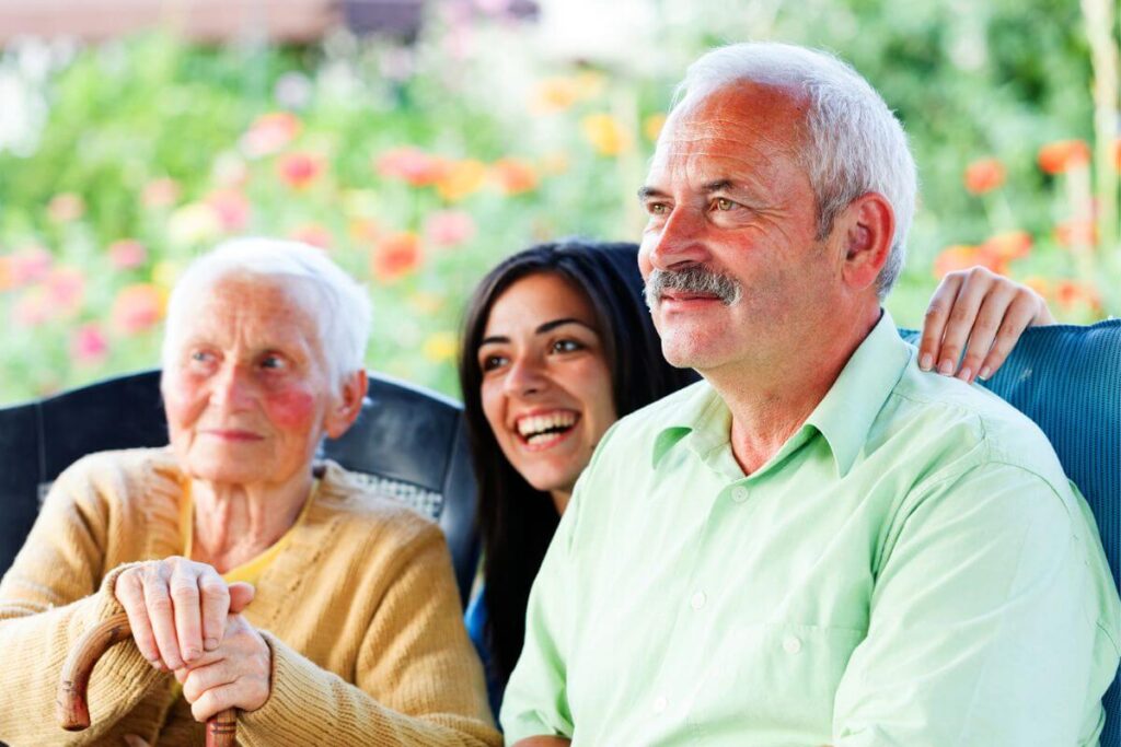 three generations, grandmother, son, and granddaughter spend time together outside in the fresh air