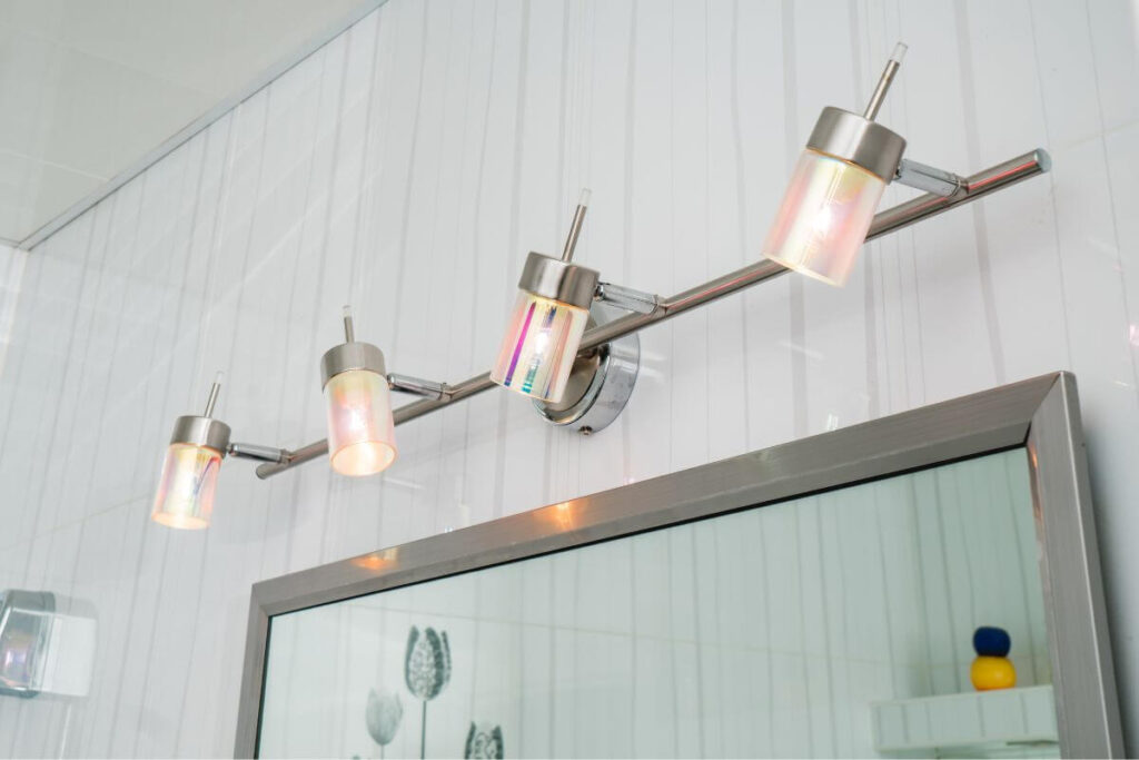 four bright lights above a bathroom mirror shows simple ways to make home safe for senior citizens