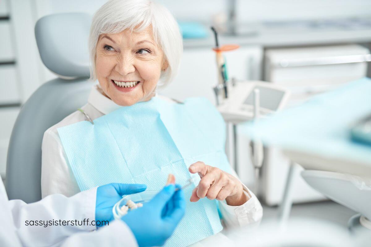 elderly woman talking to her dentist about dental hygiene habits you didn't know you need after 60.
