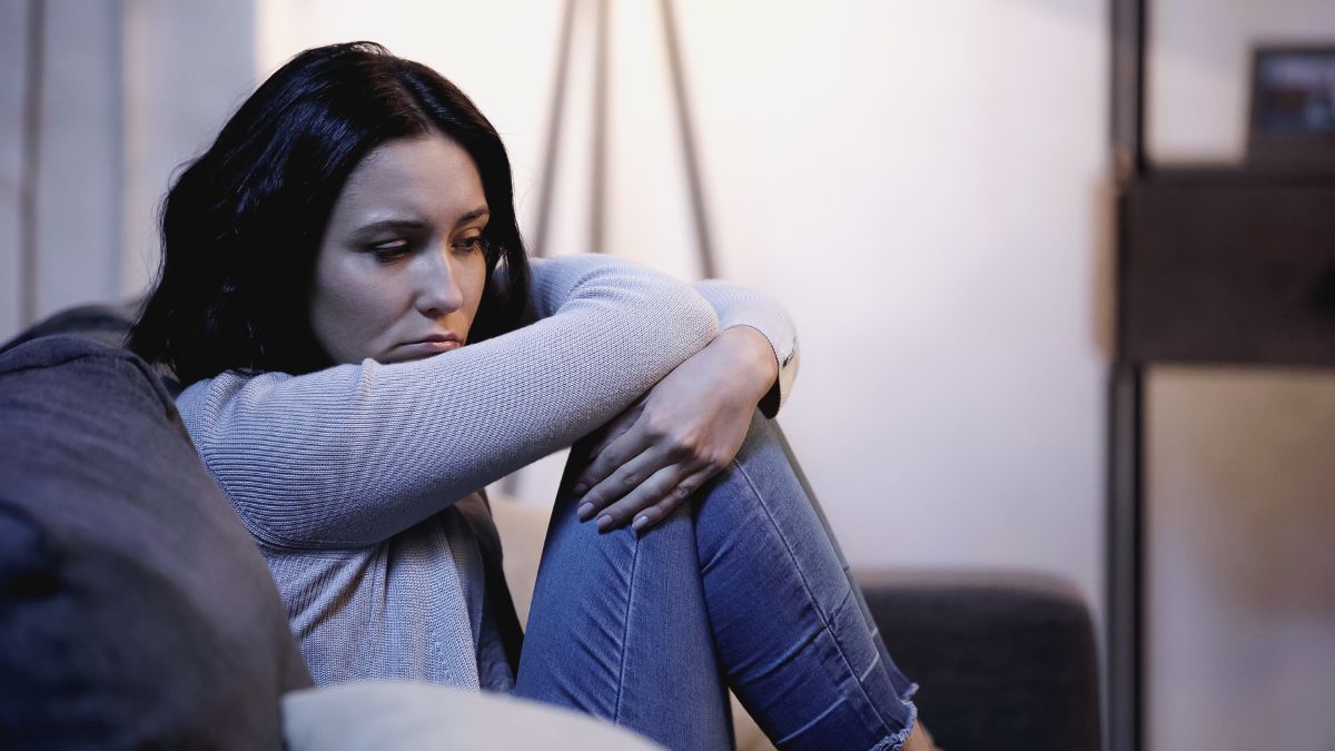 depressed sad woman on couch