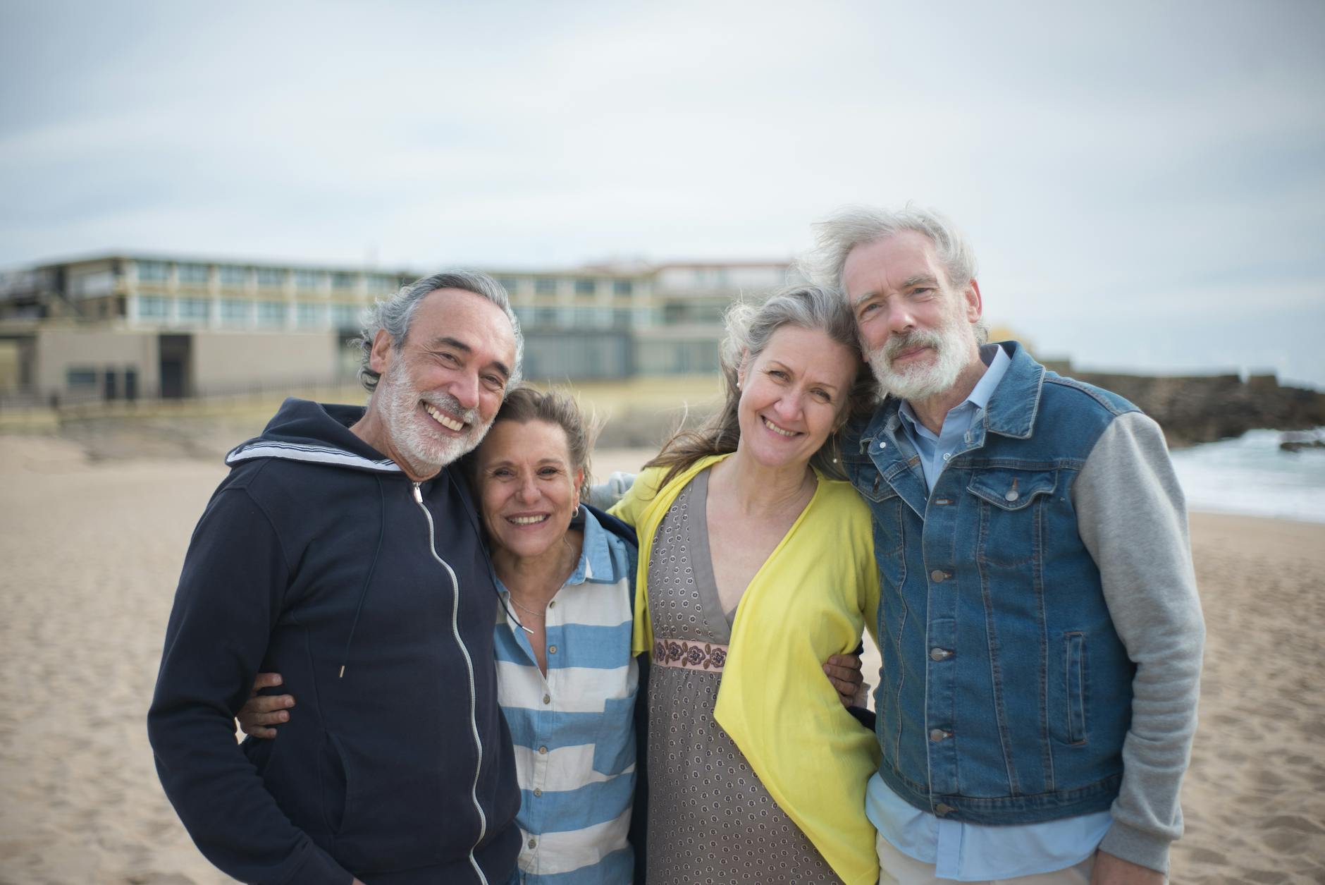 A cheerful group of mature friends enjoying a day at the beach in Portugal showcasing togetherness.Kampus Production