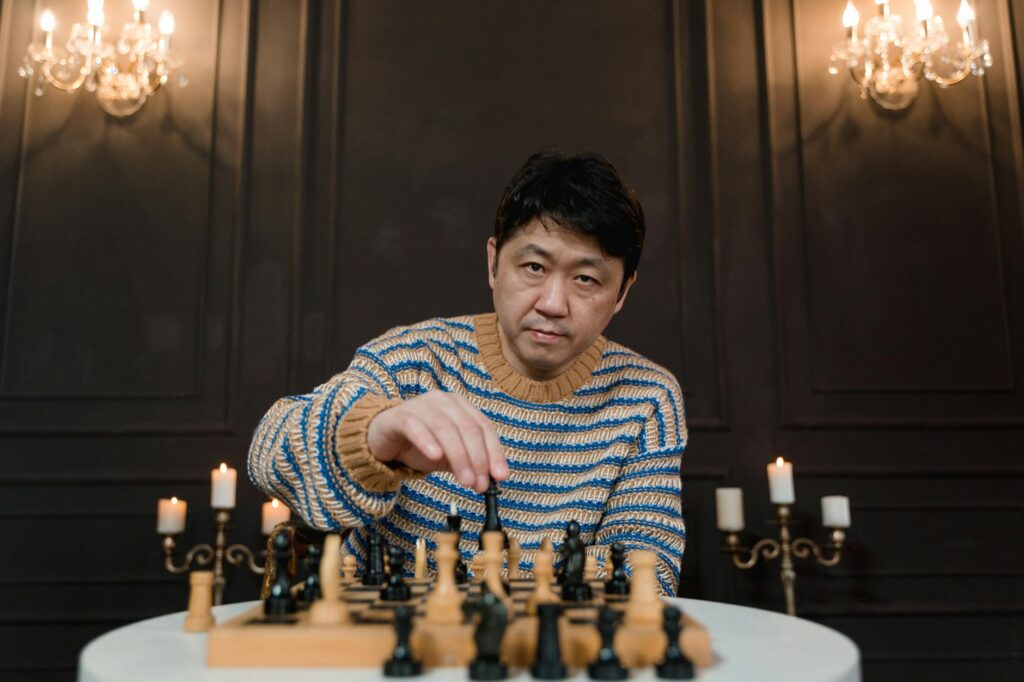 A_man_strategizes_intensely_over_a_chess_board_in_an_elegant,_candlelit_setting..Tima_Miroshnichenko