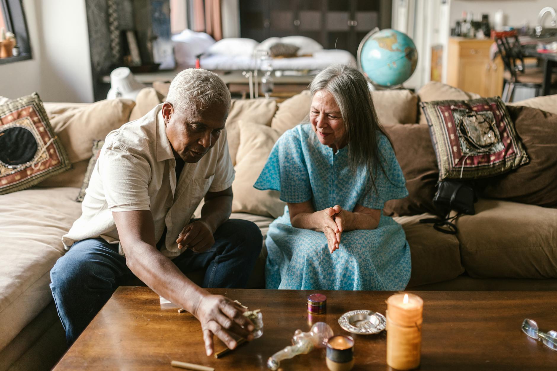 A senior couple enjoying a cozy moment with candles and herbs indoors.RDNE Stock project